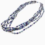 Photo of shades of blue 5-strand beaded necklace that is available to purchase. The necklace contains small bi-cone shaped beads in varying shades of blue with a barrel type fastener at the top.