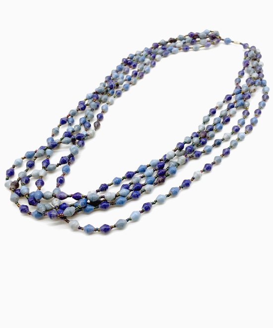 Photo of shades of blue 5-strand beaded necklace that is available to purchase. The necklace contains small bi-cone shaped beads in varying shades of blue with a barrel type fastener at the top.