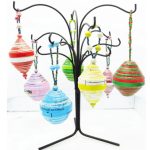 Photo of handcrafted bulb ornaments for sale in a variety of colors/patterns - reds, pinks, blues, greens, yellows and red/green striped