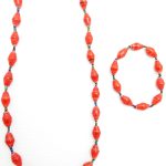 Women's matching beaded necklace and bracelet set in red beads. Handcrafted with paper beads by Ugandan women artisans.