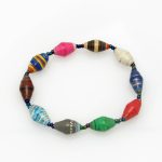 Multi-color bead bracelet closeup, The stretch bracelet contains 10 paper beads separated by seed beads.