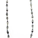 Black & white striped paper bead necklace on a plain white background. The top of the necklace is not visible.