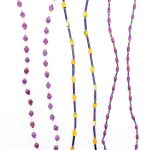 Two purple and one yellow (in the middle) beaded eyeglass leashes handcrafted from paper beads.