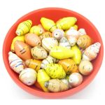 Photo of 50 of daffodil color mix of bi-cone beads that are available to purchase. The mix contains yellow, oranges, ivories and whites both solids and patterns.