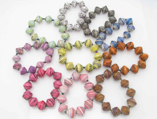 Grouping of 10 round bead stretch bracelets in many different colors containing various fleckings and patterns in them.