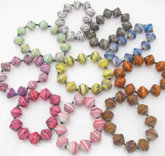 Grouping of 10 round bead stretch bracelets in many different colors containing various fleckings and patterns in them.