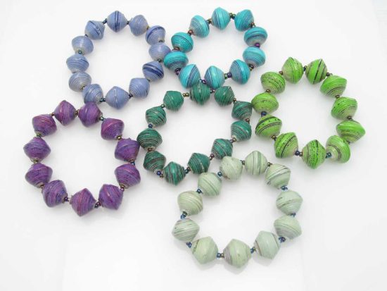 Grouping of6 round bead stretch bracelets in various shades of blues, greens and one purple.