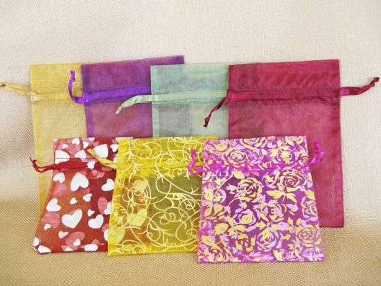 organza gift bags shown in 2 rows of 7 colors total. The 3 patterned bags are in front and solids in back.