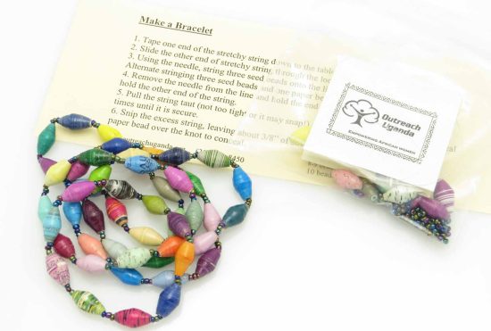 Bead bracelet making kit shown with all its parts including stretch bead cord, tiny seed beads and paper beads, plus an example of the finished product: 10 multicolor beaded bracelet. This kit listing is for 10 individual bracelet kits that can be purchased for the same price as 8 kits. Each kit makes one bracelet.