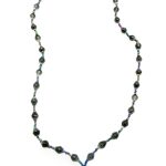 Black lanyard made of paper beads with a small seed bead loop at the bottom and a metal clip to attach your badge. The lanyard is shown on a plain white background. The top of the lanyard is not visible.