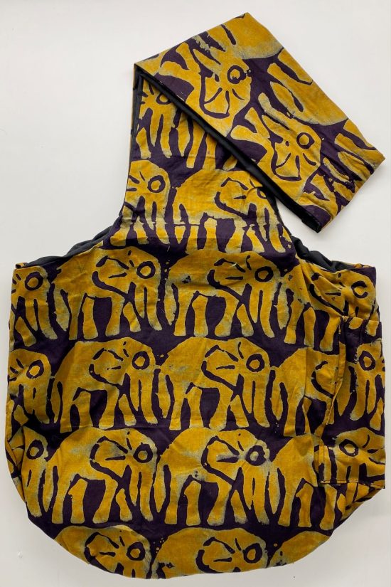 Sling bag in all over deep yellow elephants on a very dark background.