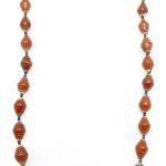 Brown paper bead necklace on a plain white background. The top of the necklace is not visible.