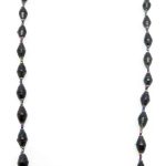 Black paper bead necklace on a plain white background. The top of the necklace is not visible.