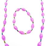 Women's matching beaded necklace and bracelet set in lavender. Handcrafted with paper beads by Ugandan women artisans.