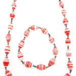 Women's matching beaded necklace and bracelet set in red & white striped pattern. Handcrafted with paper beads by Ugandan women artisans.