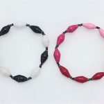 Photo of 2 women's single strand bracelet that you can special order with a special color combination. Shown are one bracelet with black and white alternating beads. The 2nd bracelet contains 3 different shades of pink beads.