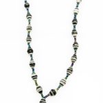 Black & white striped lanyard made of paper beads with a small seed bead loop at the bottom and a metal clip to attach your badge. The lanyard is shown on a plain white background. The top of the lanyard is not visible.