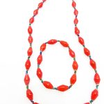 Women's matching beaded necklace and bracelet set in bright red. Handcrafted with paper beads by Ugandan women artisans.