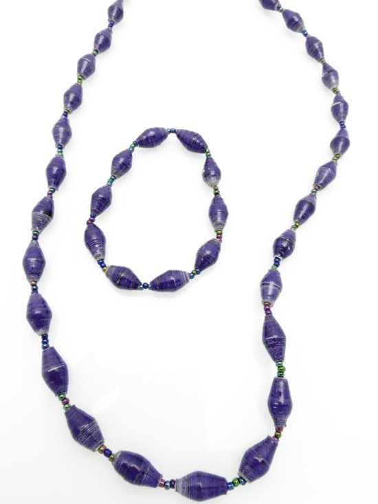 Women's matching beaded necklace and bracelet set in a blue color. Handcrafted with paper beads by Ugandan women artisans.