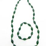 Women's matching beaded necklace and bracelet set in green. Handcrafted with paper beads by Ugandan women artisans.