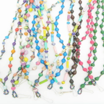 Group of 12 lanyards in a variety of colors made of paper beads with a small seed bead loop at the bottom and a metal clip to attach your badge. The lanyard is shown on a plain white background. The top of the lanyard is not visible.