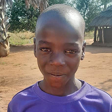 Ugandan child, Paul, lives in a mud hut. He hopes for a sponsor so he can go to school.